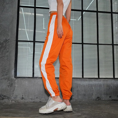 Pantaloni della tuta arancioni con stampa - arancia / s